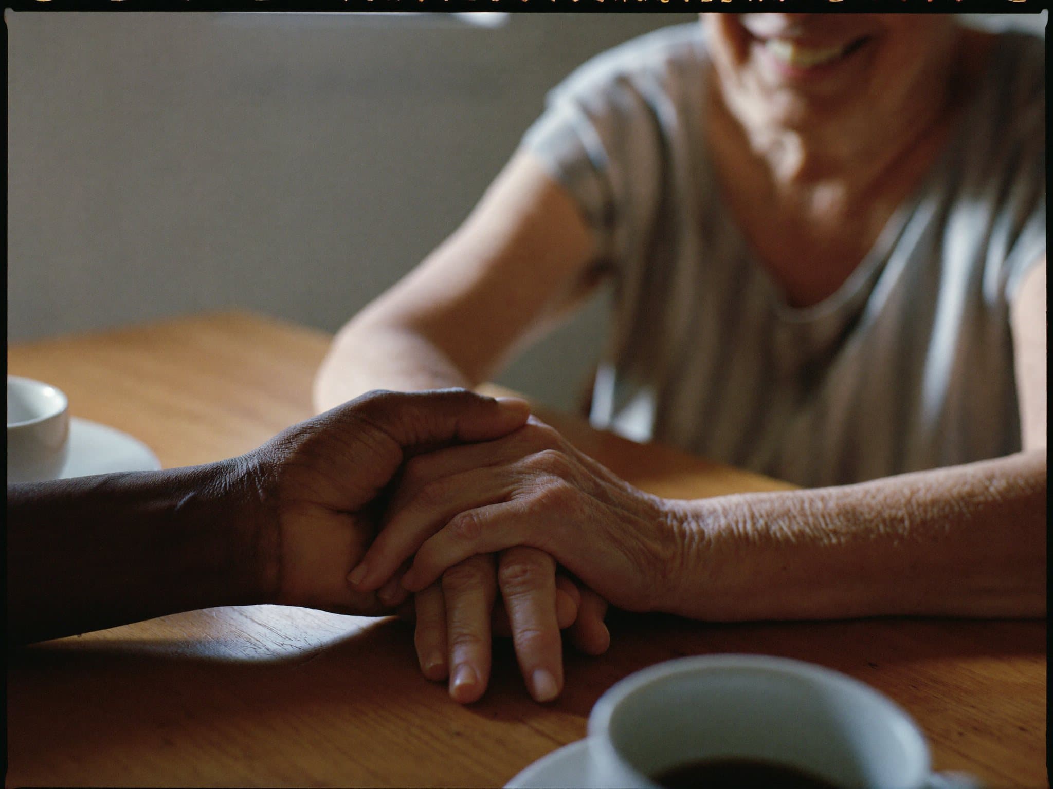 Hands held together in a quiet moment of care and trust
